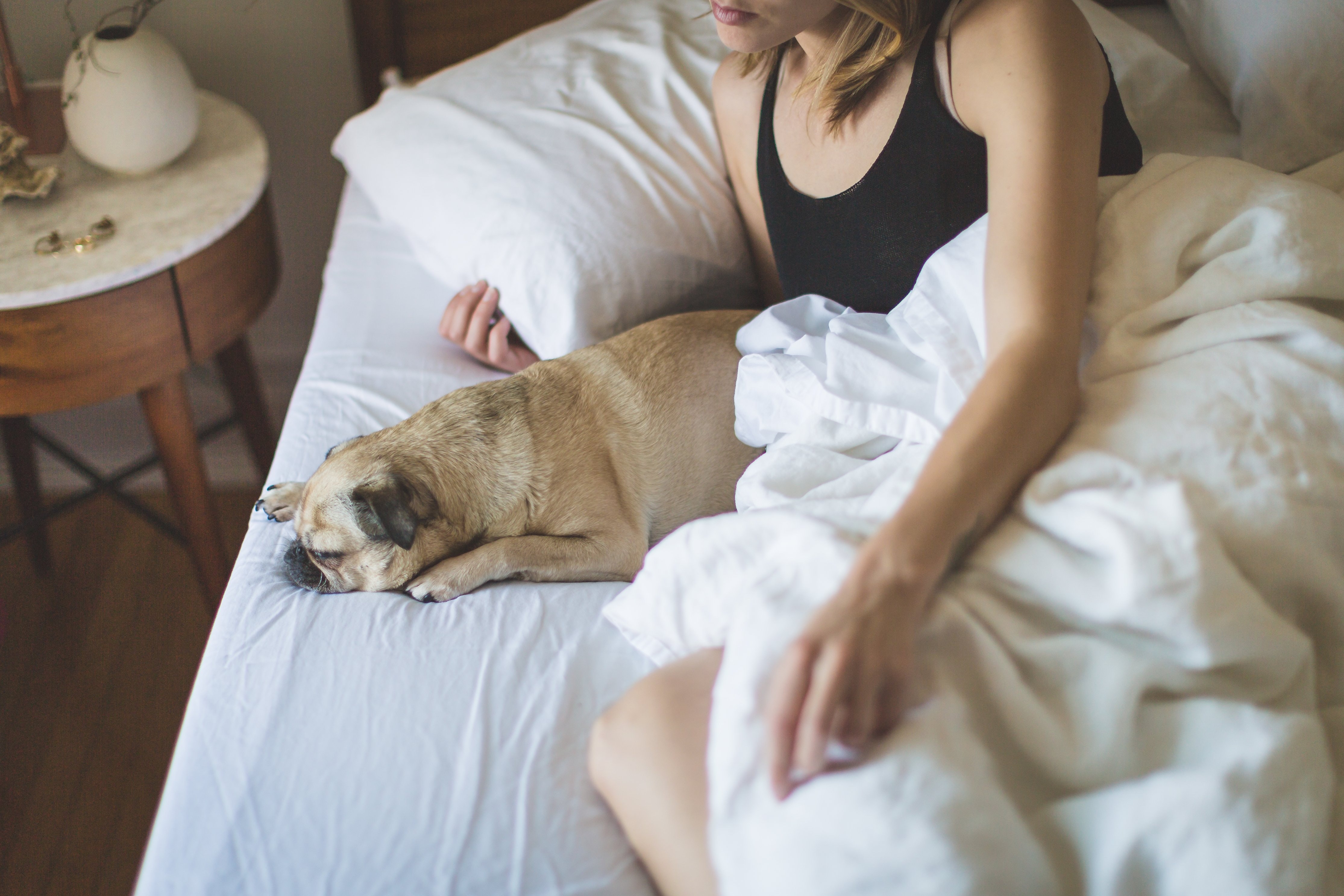 woman in bed with dog
