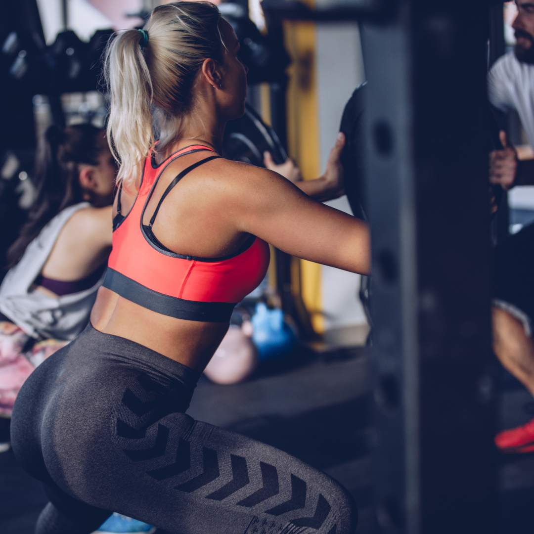 woman squatting in gym