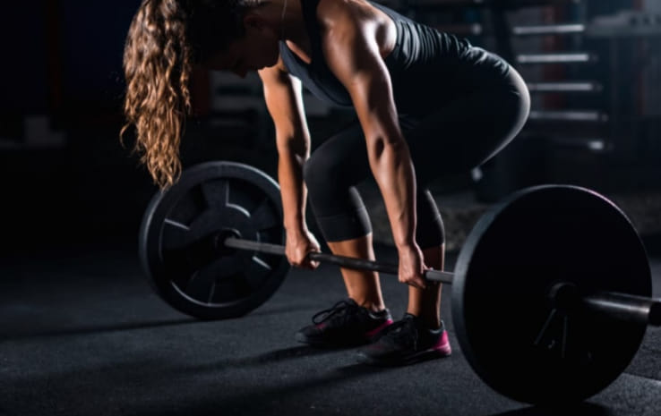 woman deadlifting barbell