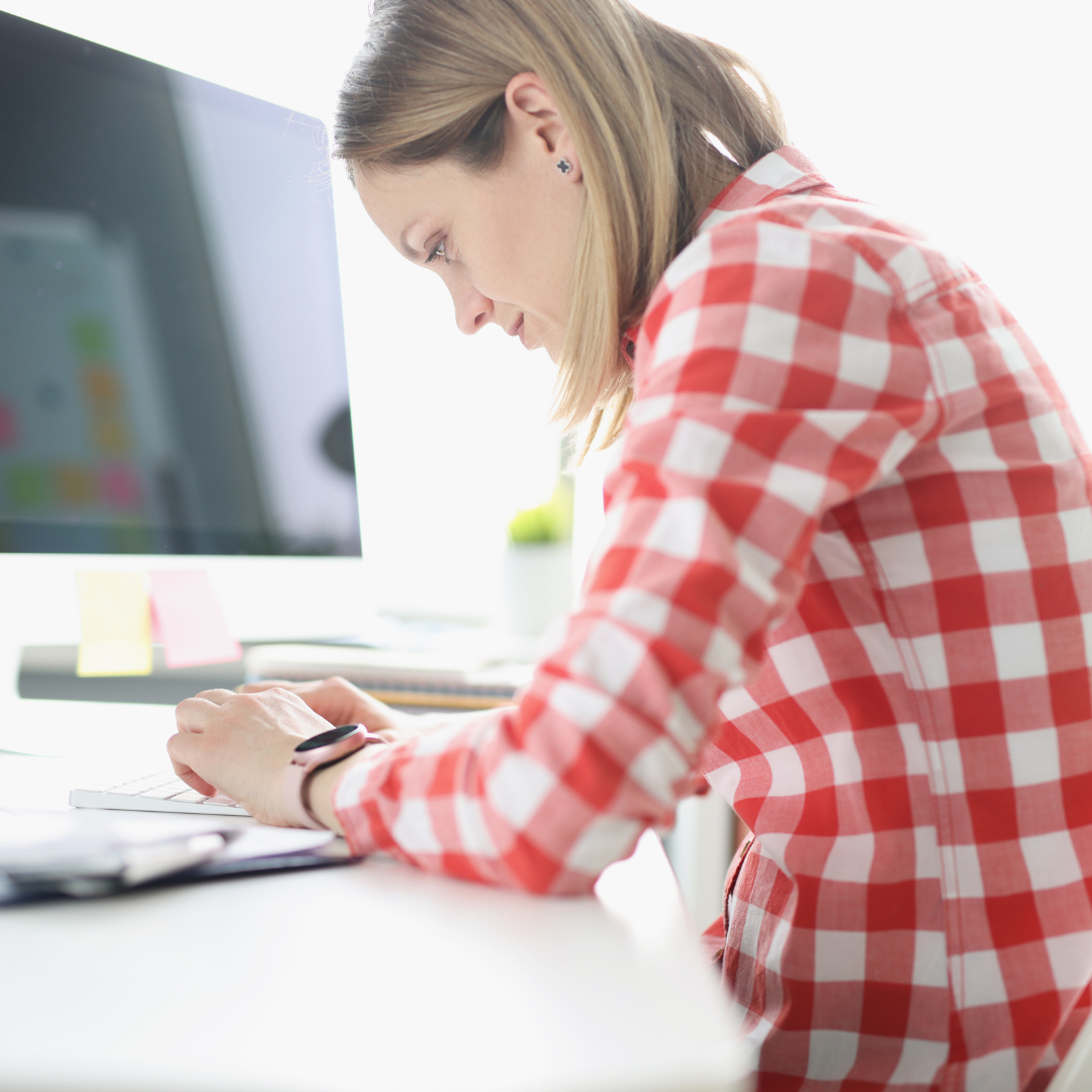 woman hunched over desk